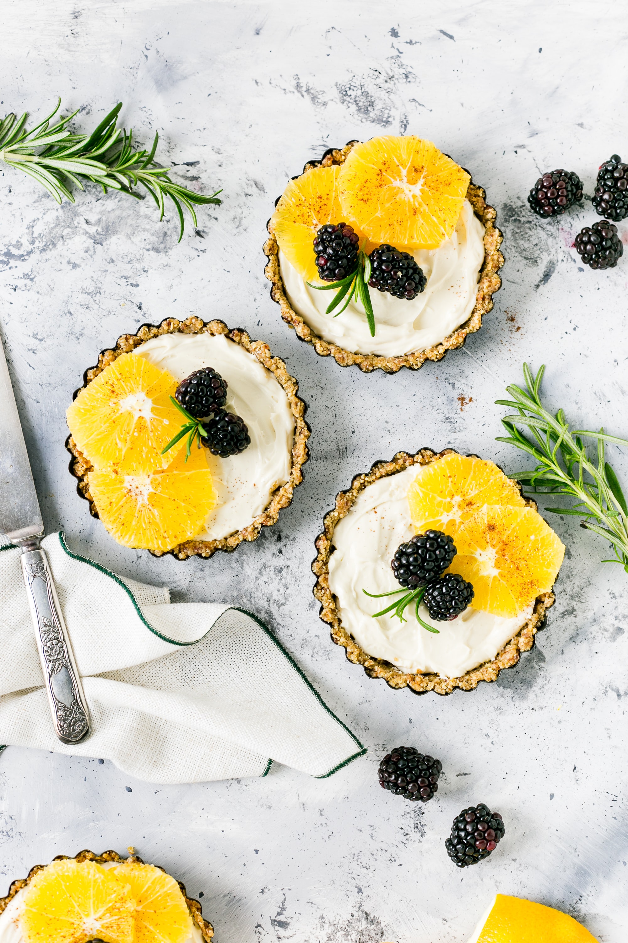 individual cheesecakes with yellow fruit on top. 