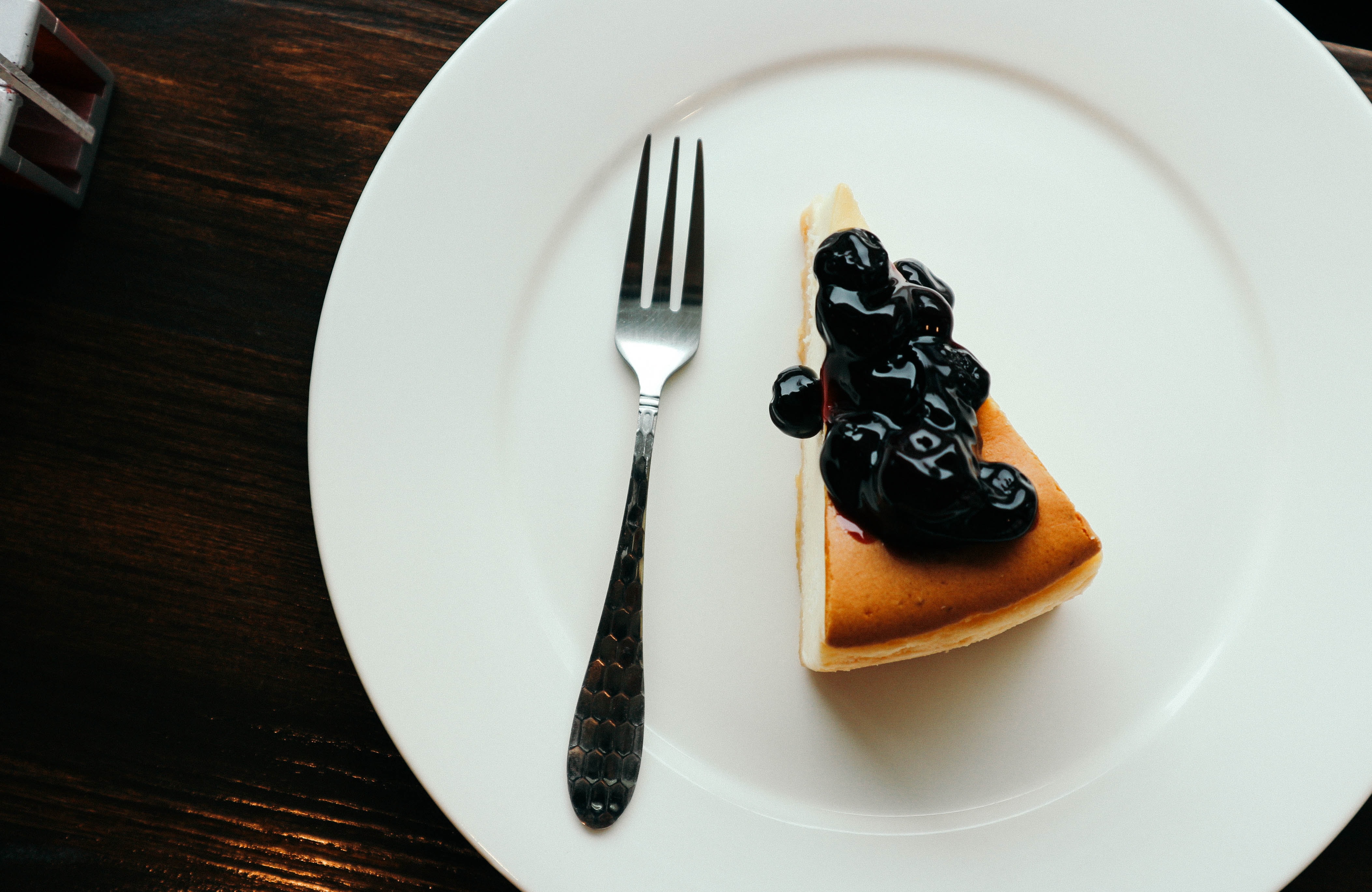 A slice of cheesecake with blueberries on top